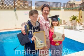 A mother with her 2 children who have both completed a language curs
