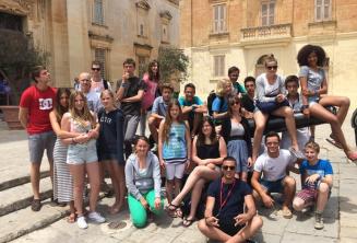 studenți sitting on a canon in Mdina